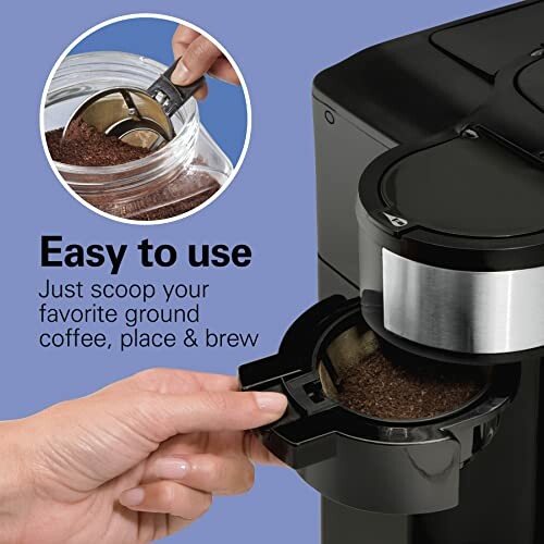 Person using coffee maker with scoop for ground coffee.