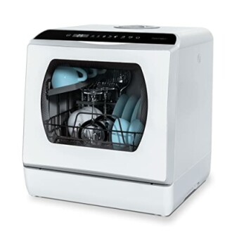 Compact countertop dishwasher with open door showing clean dishes.