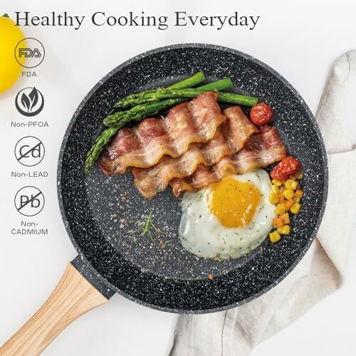 Non-toxic frying pan with bacon, egg, asparagus, cherry tomatoes, and corn.