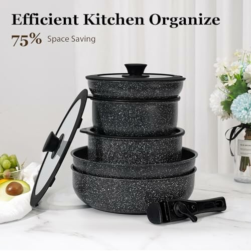 Stacked black speckled cookware with detachable handle for efficient kitchen organization.