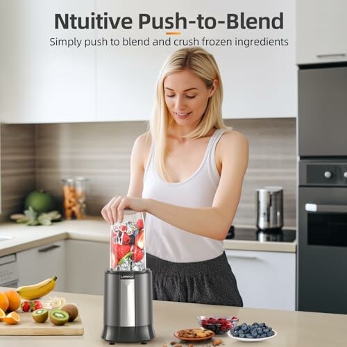 Woman blending fruits in kitchen with push-to-blend blender.